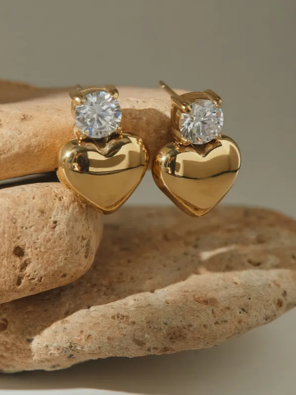 Gold-plated heart stone studs displayed together �? lightweight conversation-starting heart earrings.