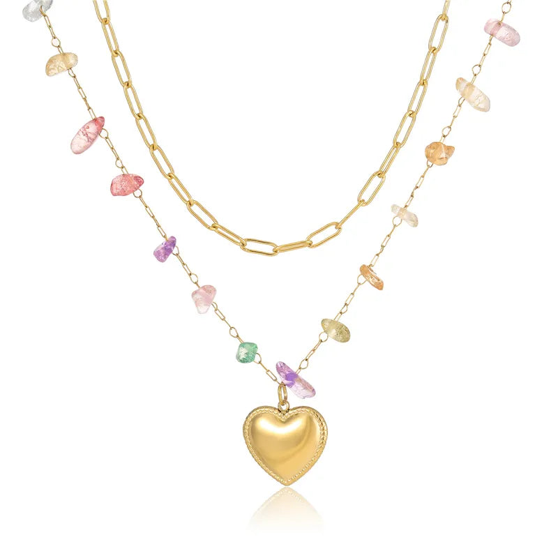 Vaira rainbow stone necklace styled with the heart charm �? versatile layered piece for everyday and festive looks.