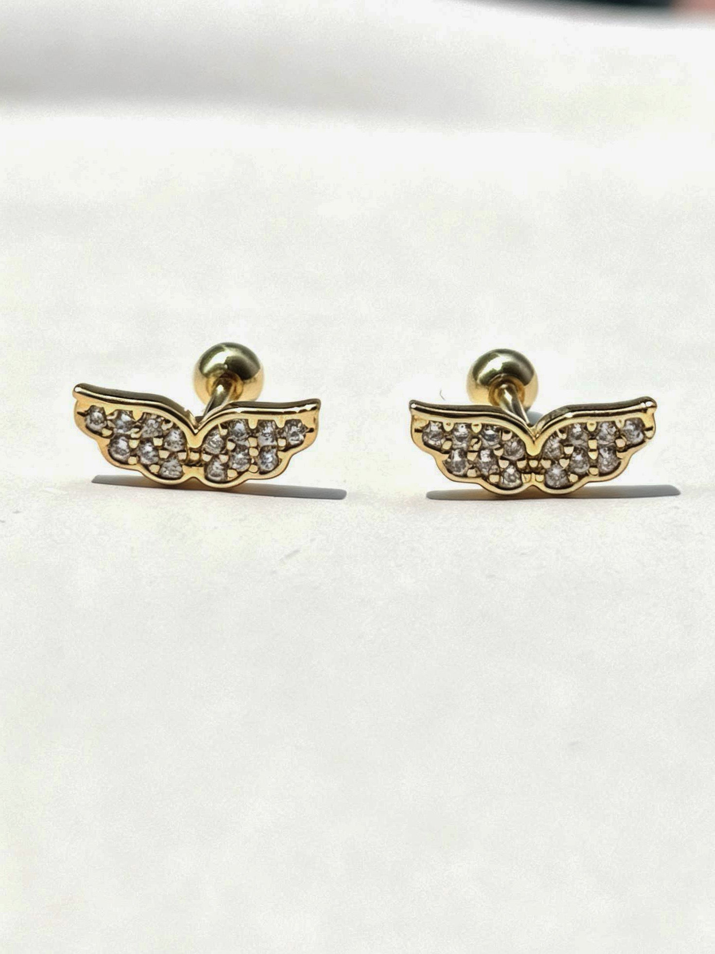18k gold-plated wing ball-back stud earrings �? sleek minimal hypoallergenic wing studs, anti-tarnish and waterproof for everyday wear.