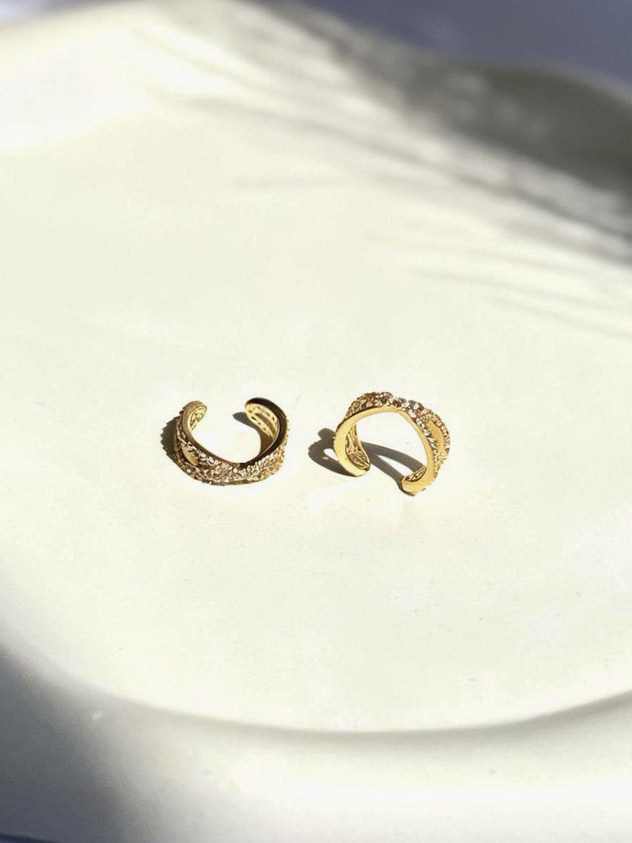 Close-up of gold-plated interlock ear cuff �? sleek lightweight cuff for everyday and festive ear stacks.