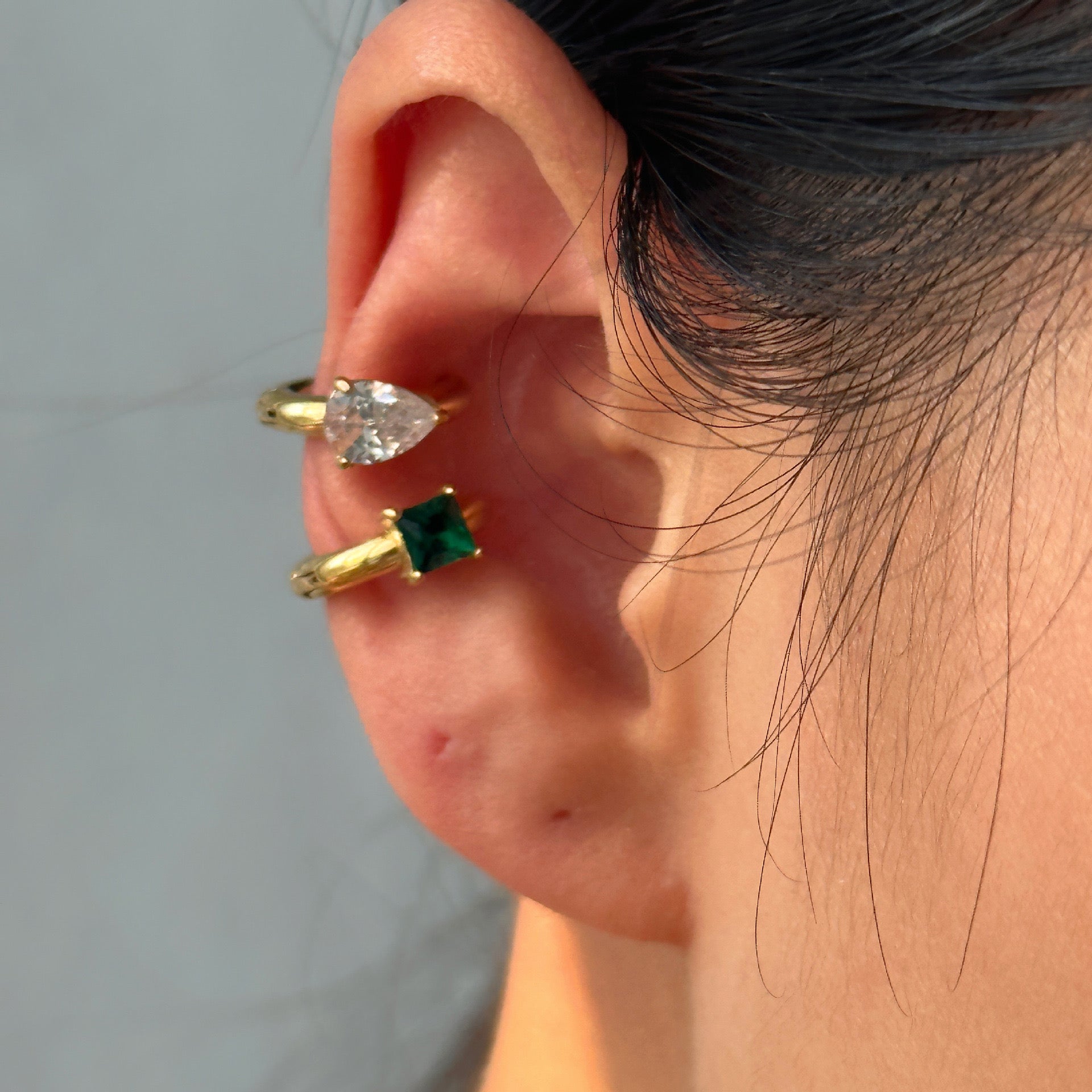 Detail view of 18k gold-plated white stone ear cuff �? single-piece cuff for festive and everyday ear stacks.