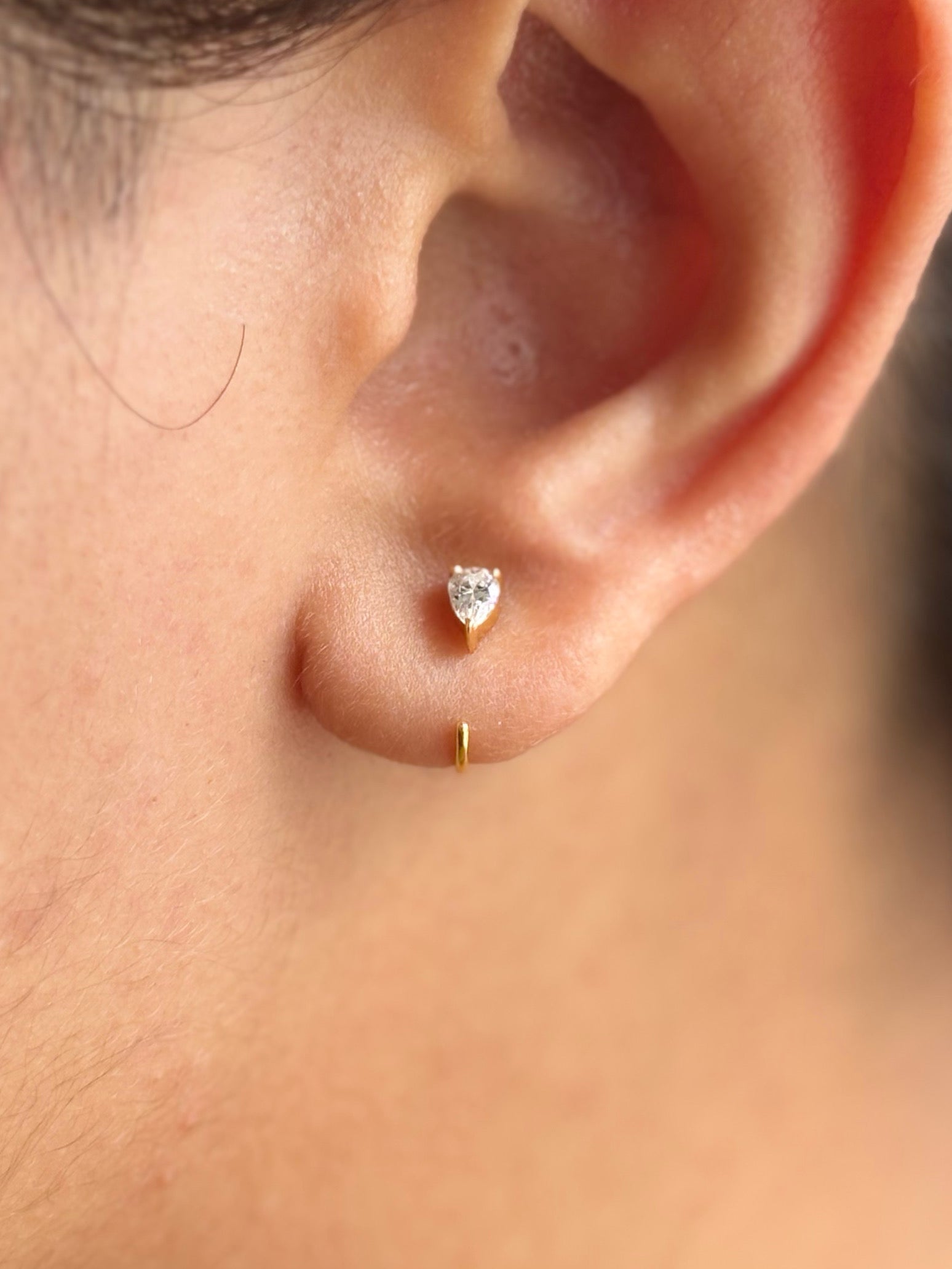 Pair of sterling silver pear hoop earrings in gold finish �? poke-free hypoallergenic hoops for kids and sensitive ears.