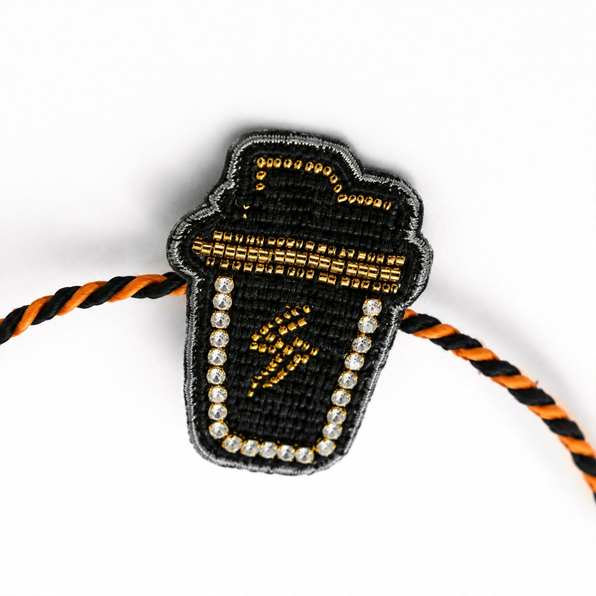 Trendy cup symbol rakhi with black and yellow braided thread
