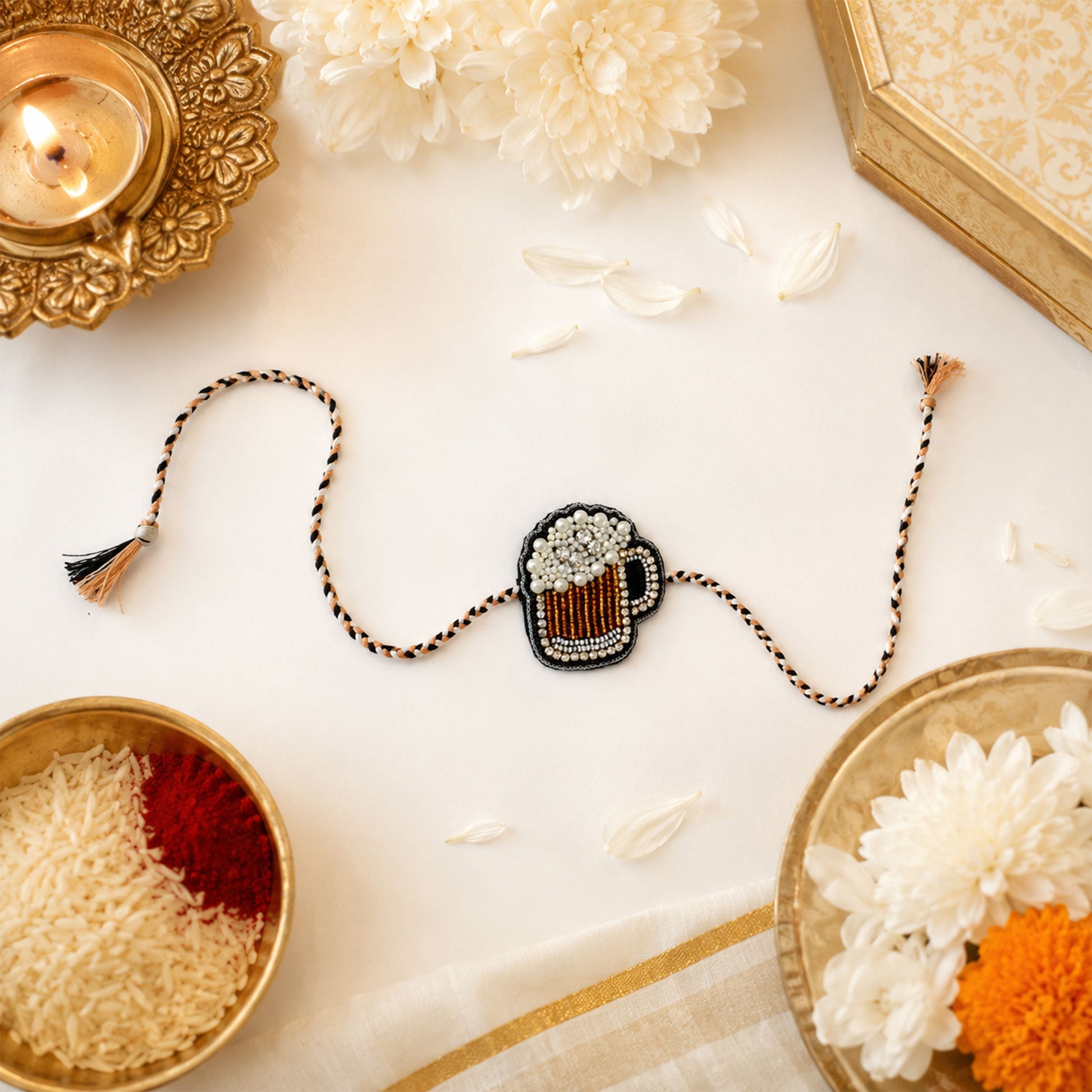 Close-up view of mug rakhi with pearl and stone detailing