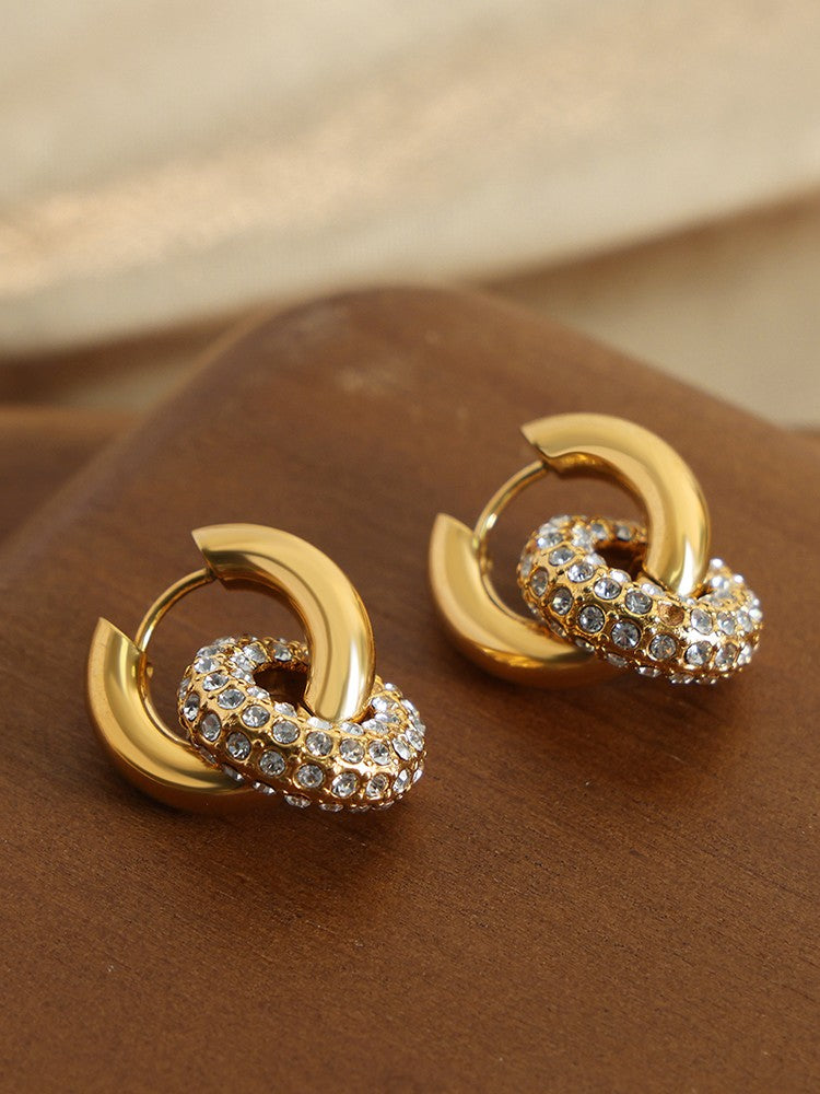 Close-up of 18k gold-plated huggie earrings with white stone charm �? lightweight, hypoallergenic, day-to-night.