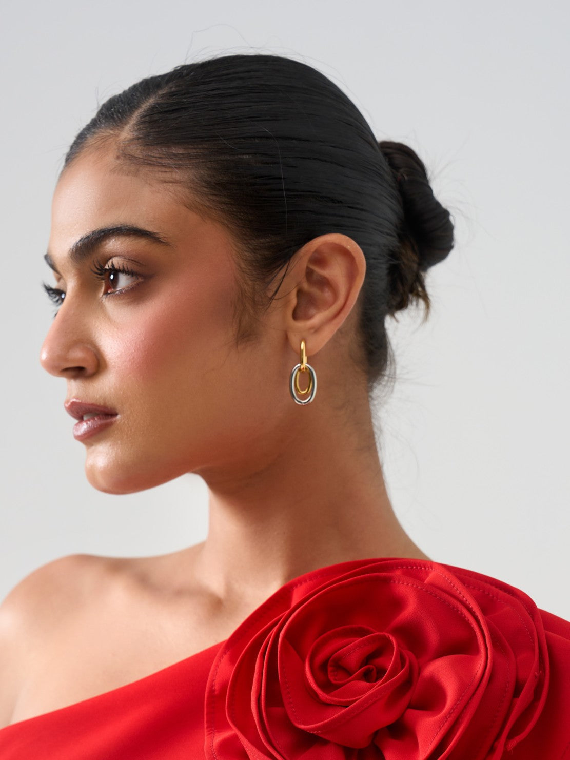Styled view of Manya drop earrings �? 18k gold-plated mixed metal drops for evening and casual wear.