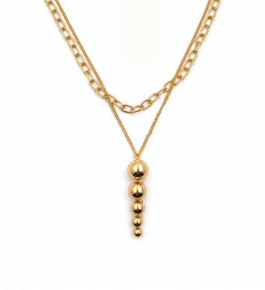 Gold layered graduated bead pendant necklace on white background