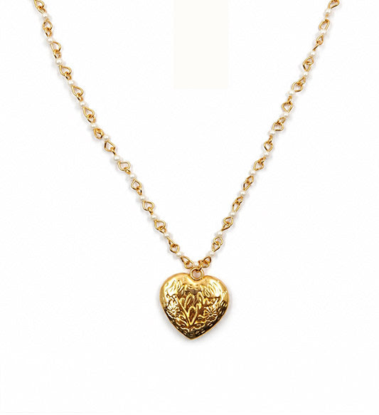 Gold pearl heart locket pendant necklace on white background