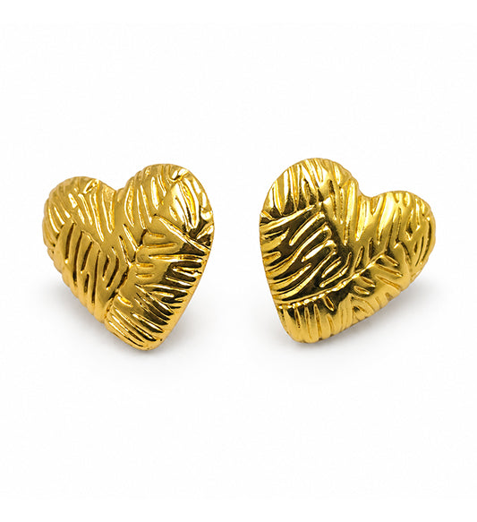 Gold textured heart stud earrings pair on white background