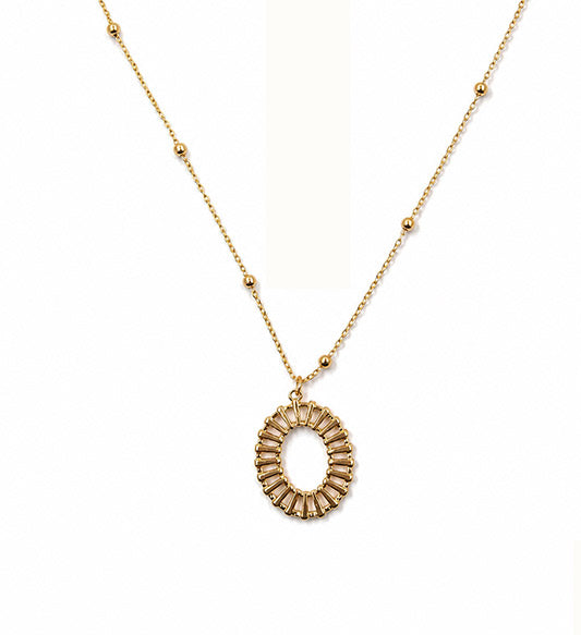 Gold oval sunburst pendant necklace on white background