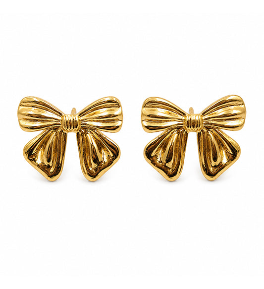Gold bow stud earrings pair on white background