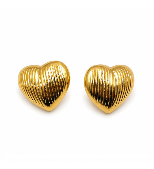 Gold ribbed heart stud earrings pair on white background