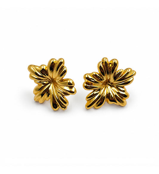 Gold floral stud earrings pair on white background