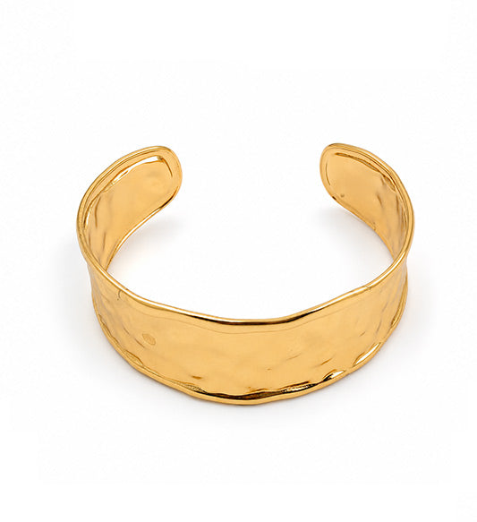 Gold hammered open cuff bracelet on white background