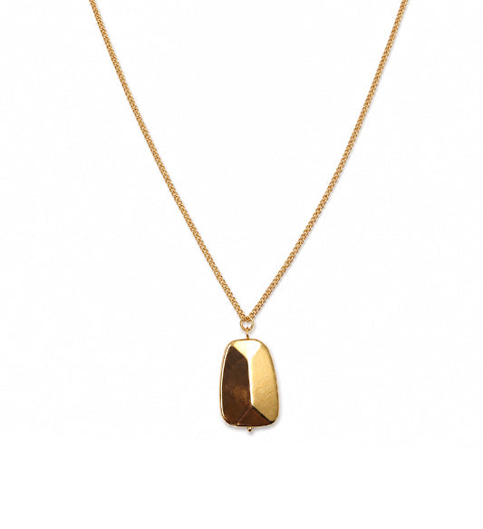 Gold geometric pendant necklace on white background