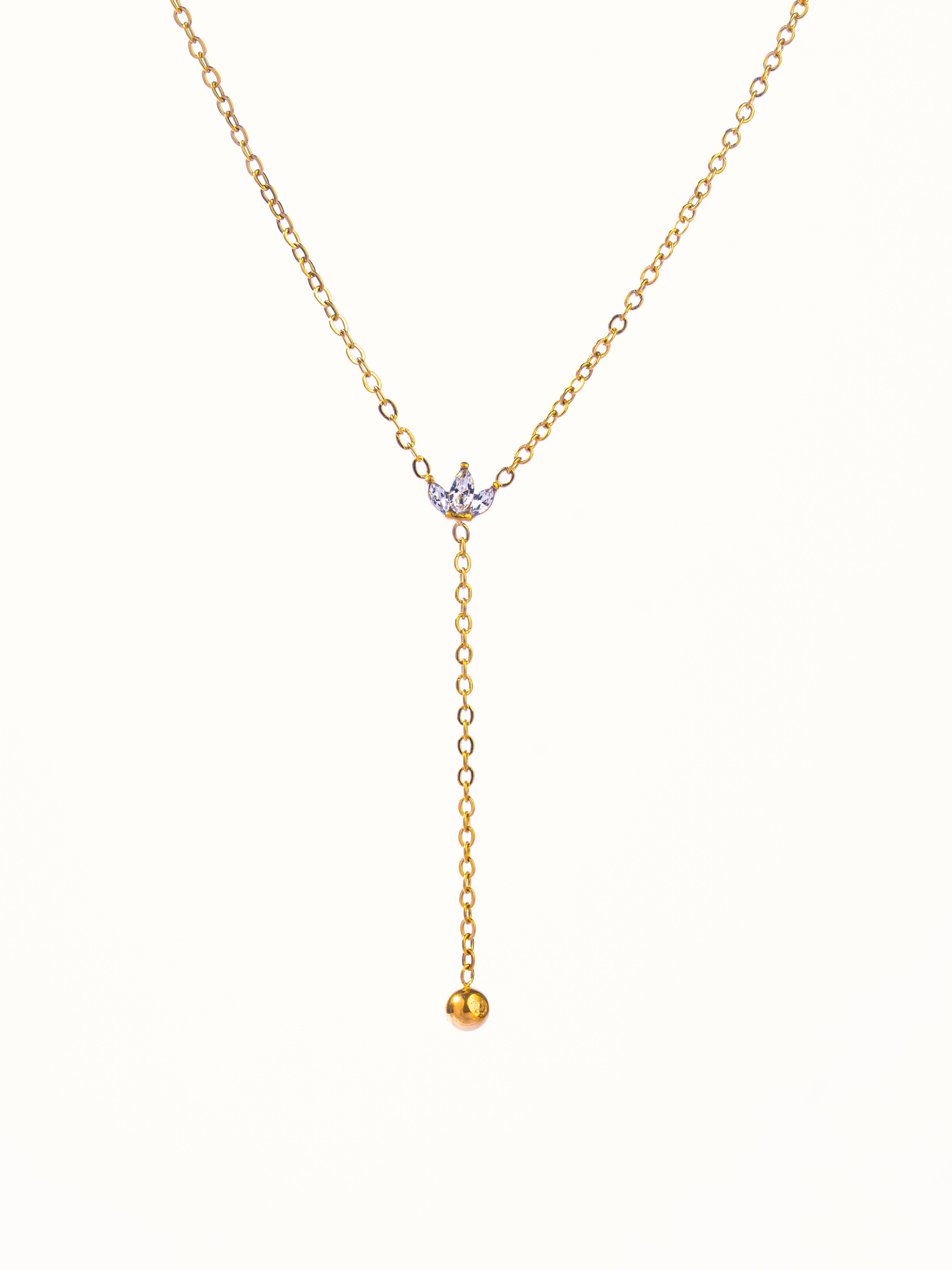 Close-up of Stella lariat �? dainty white stone leaf charms on gold-plated chain for deep necklines and evening.