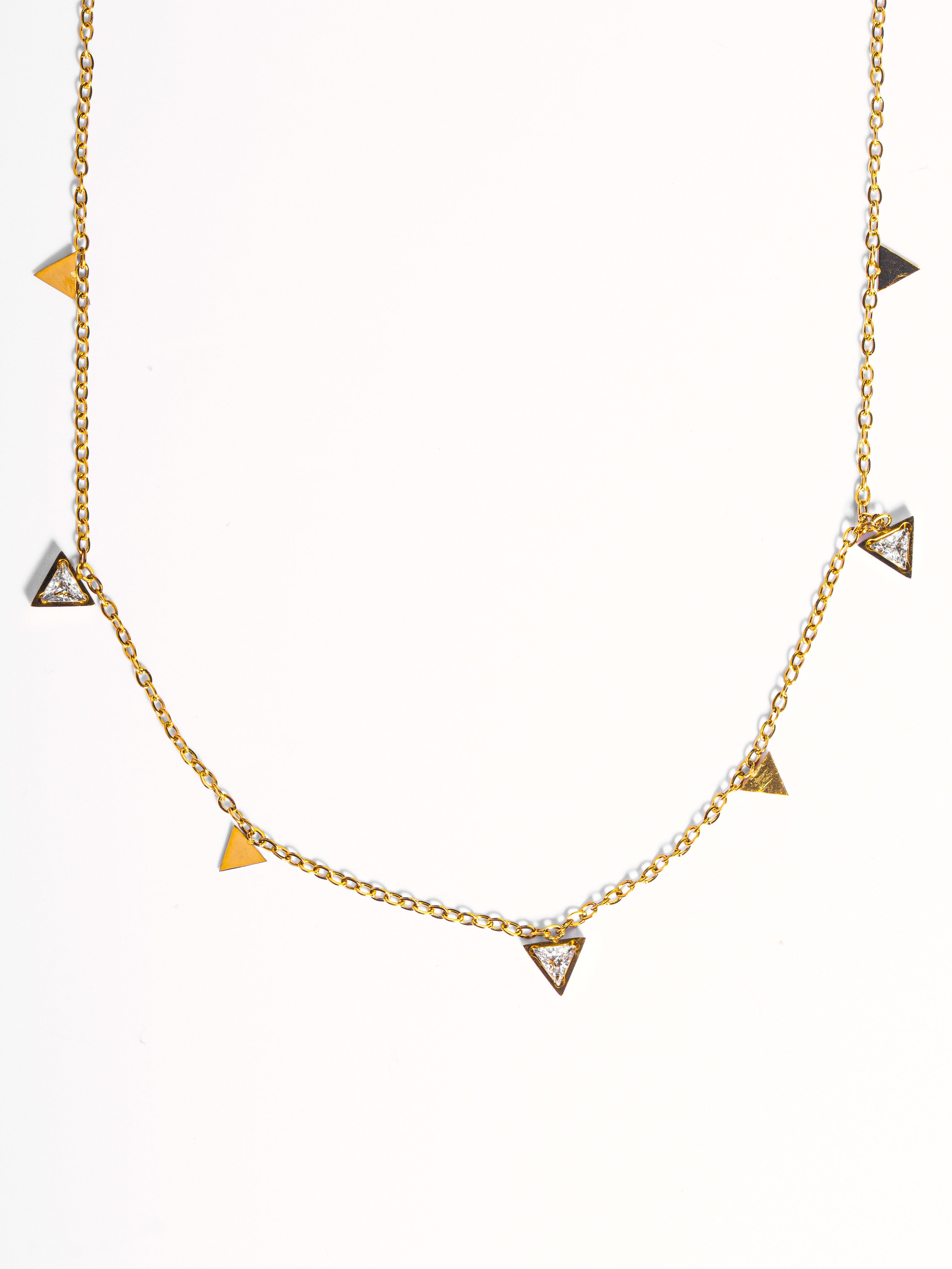 Close-up of Claire choker �? delicate triangle white-stone charms on gold-plated chain for evening looks.