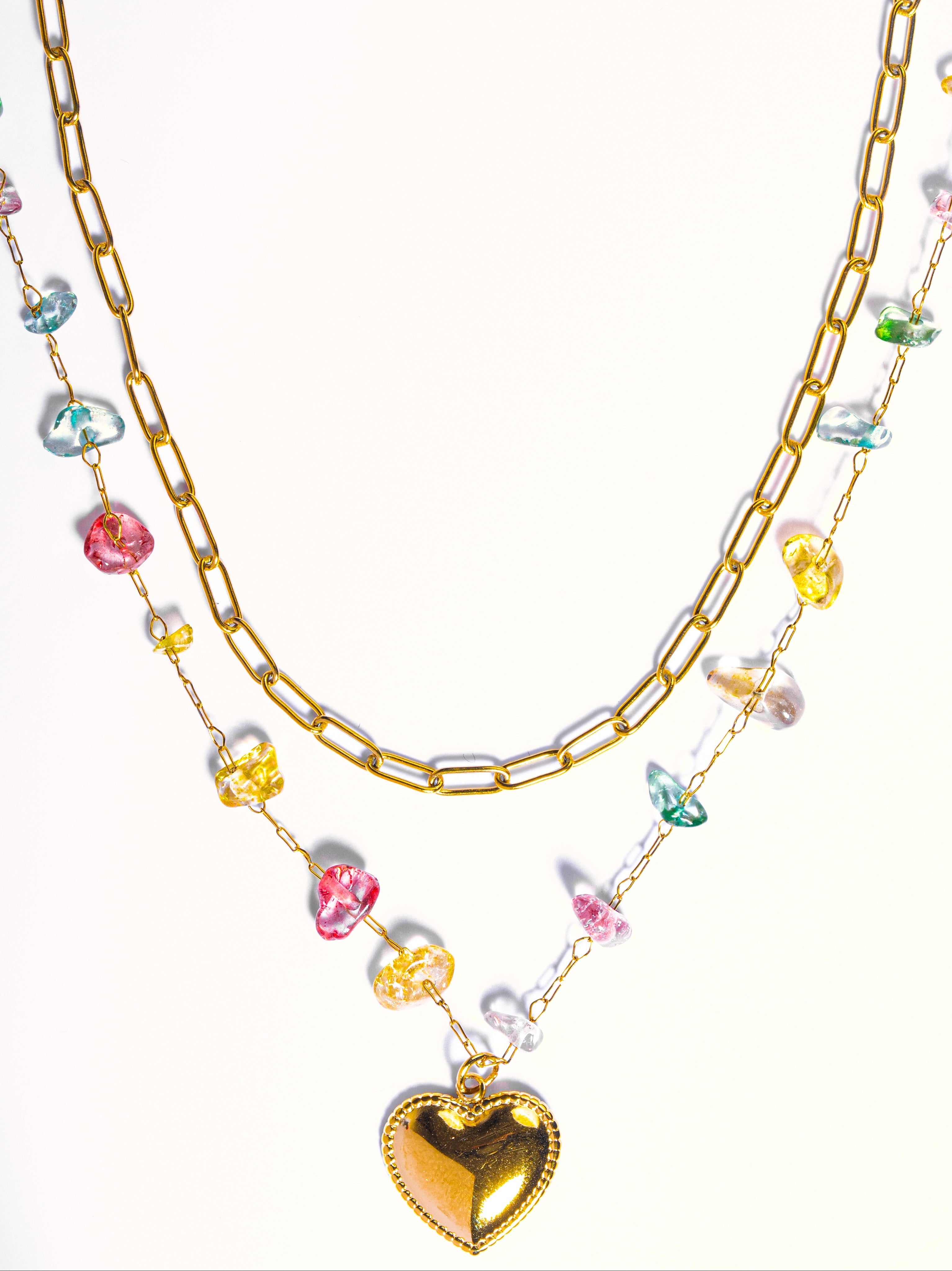 Close-up of Vaira layered necklace �? rainbow stone double layer with heart charm on gold-plated chain.