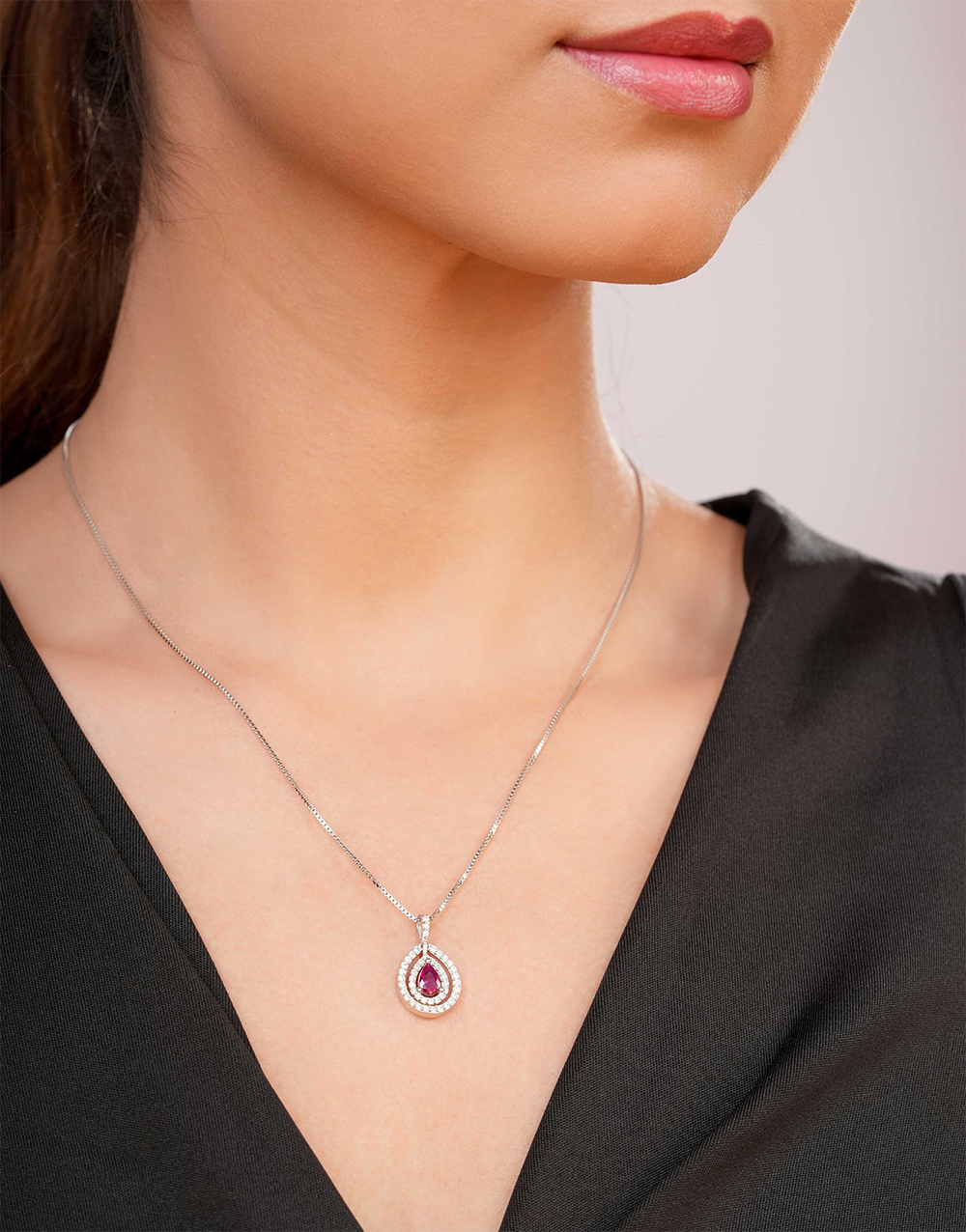 Elegant teardrop ruby pendant with sparkling CZ accents