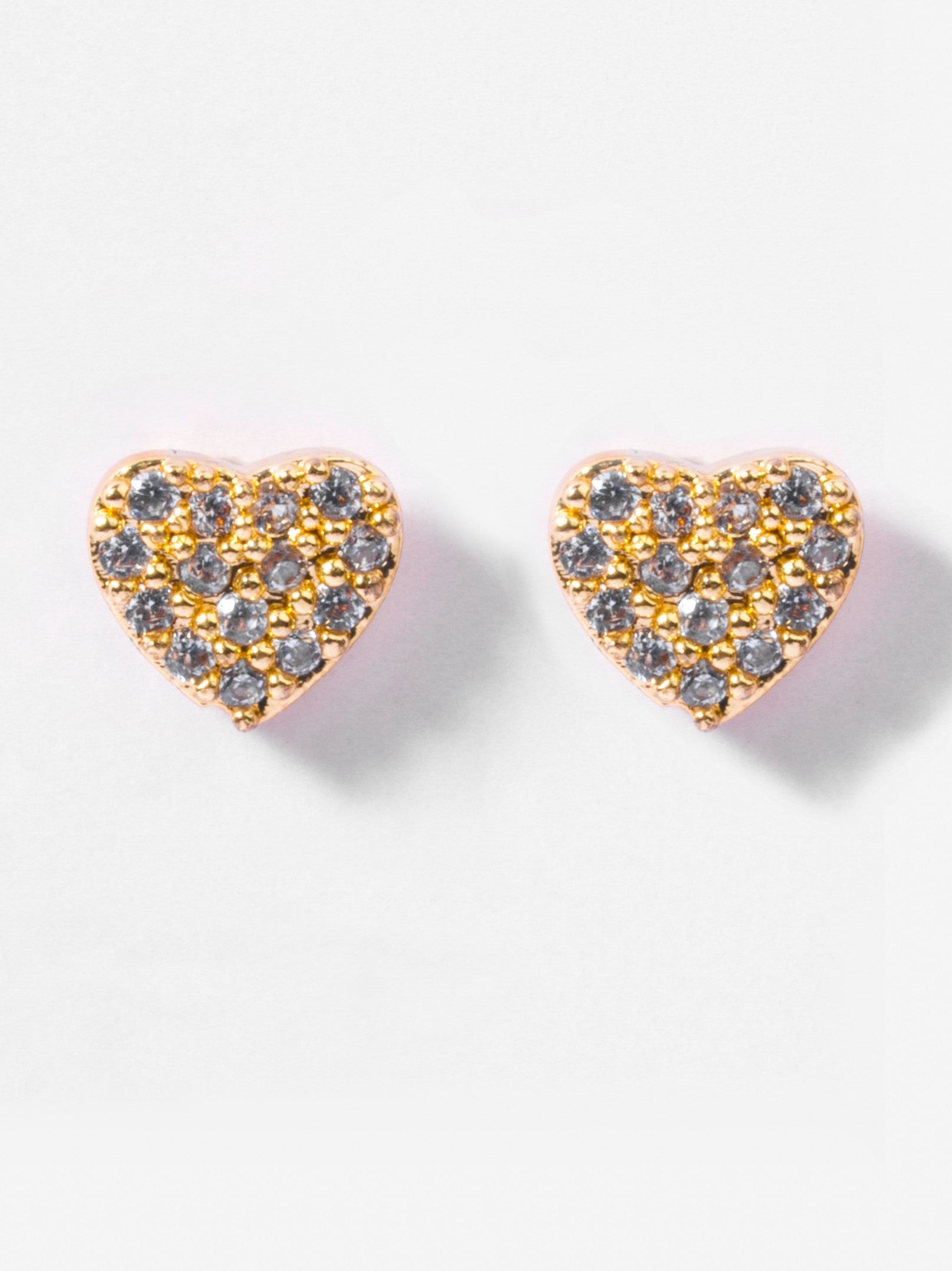 Close-up of heart flat-back stud earrings �? 18k gold-plated sleek modern heart studs for casual wear.