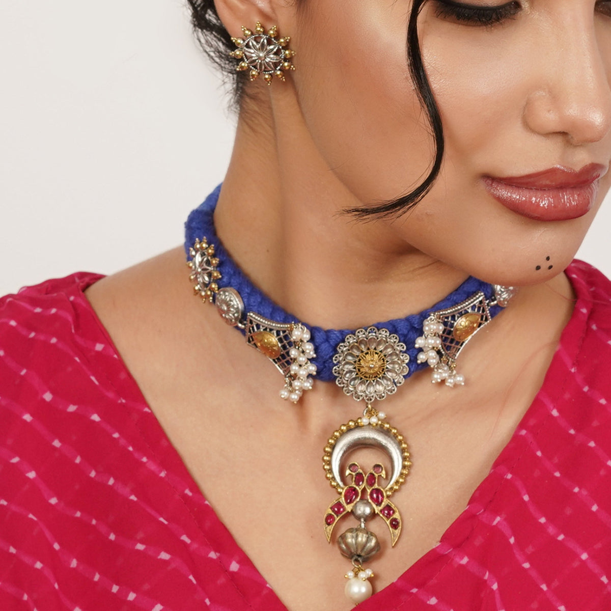 A richly detailed necklace where a textured braid meets intricate ornamental accents. The design feels expressive and thoughtfully layered, creating a piece that naturally draws the eye.