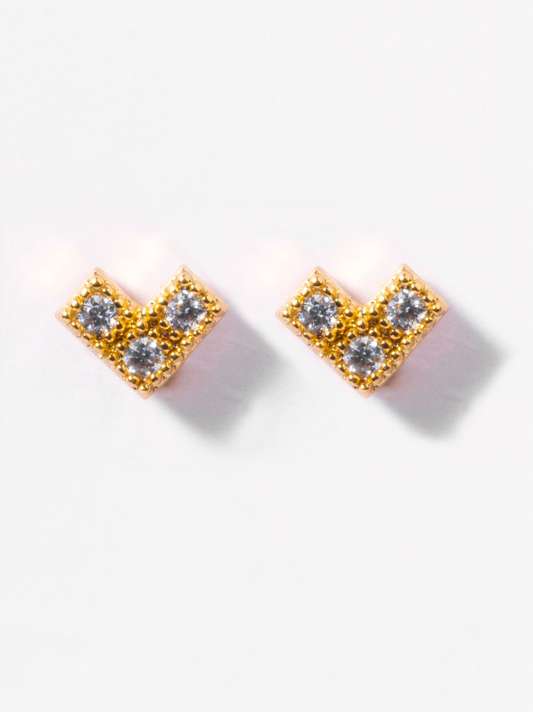 Close-up of Rory ball-back stud earrings �? 18k gold-plated sleek modern studs for casual wear.